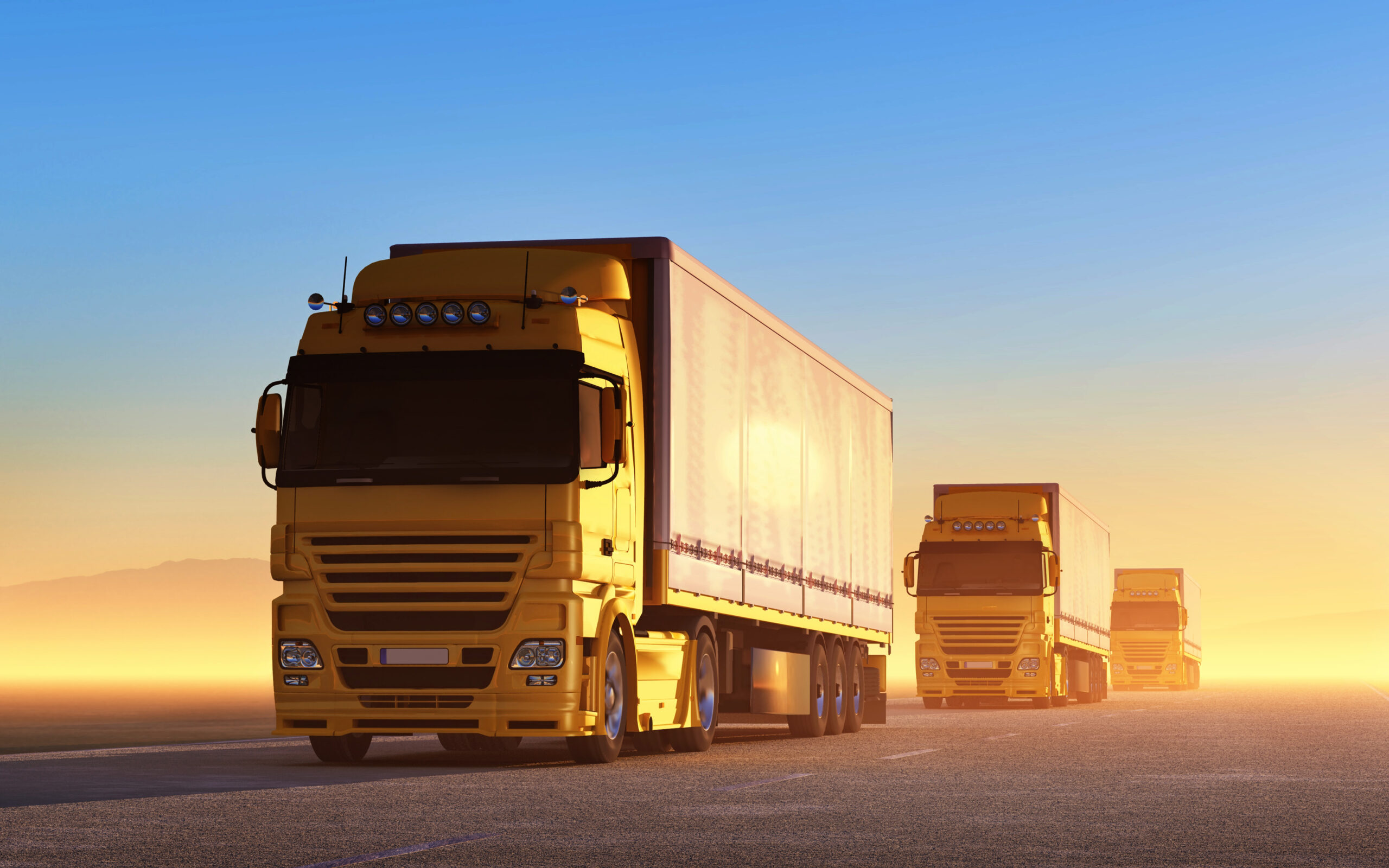 Convoy of yellow trucks on the road