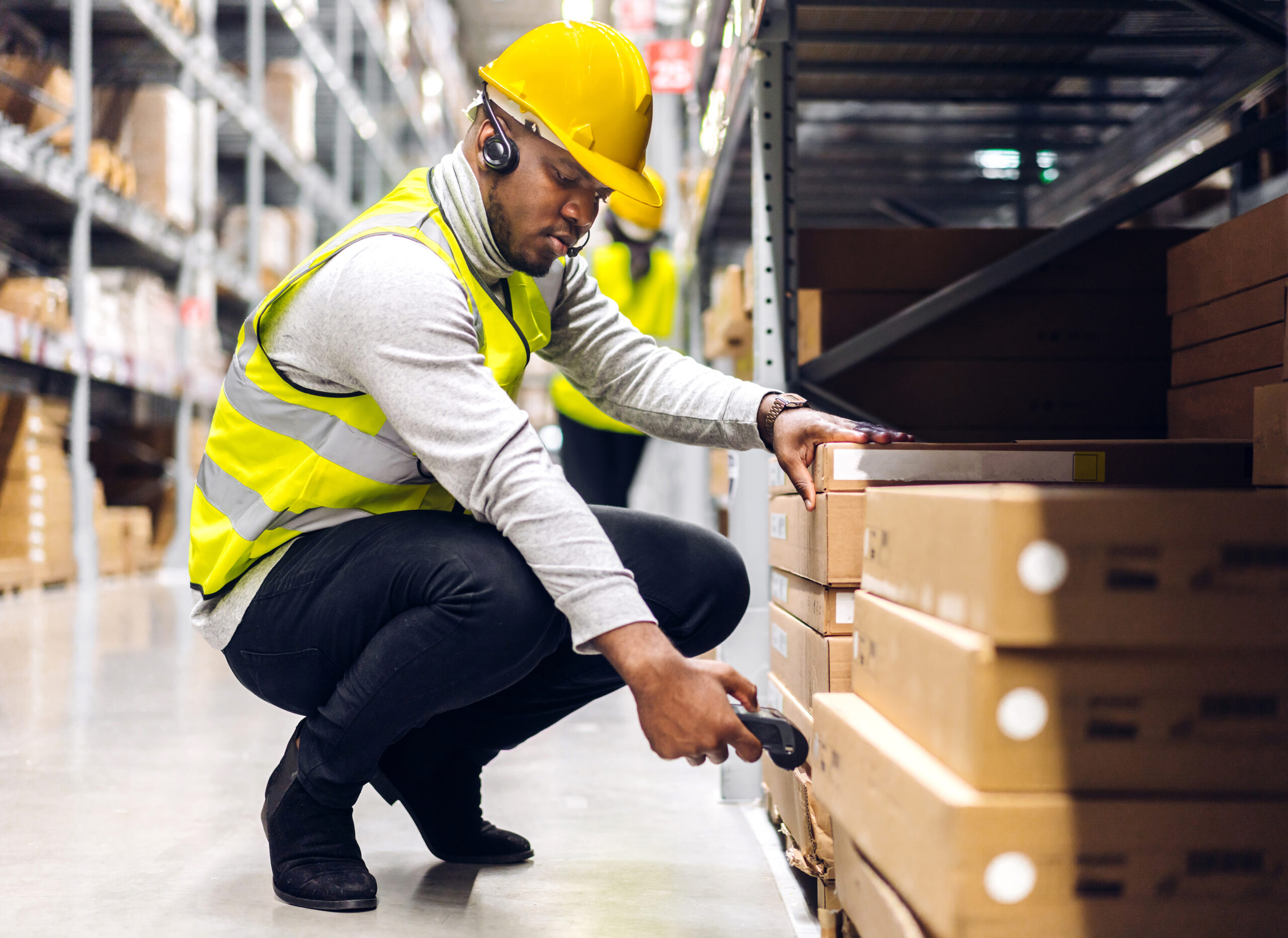 Portrait,Of,African,American,Engineer,Man,Scanning,Package,With,Barcode